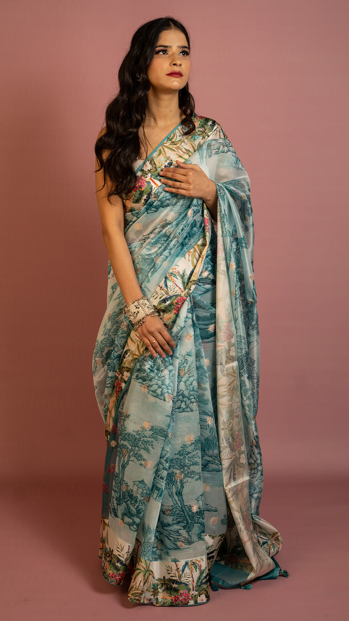 Aqua blue scenic printed designer saree with artistic landscape pattern and elegant drape