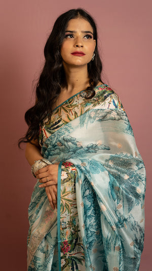 Aqua blue scenic printed designer saree with artistic landscape pattern and elegant drape