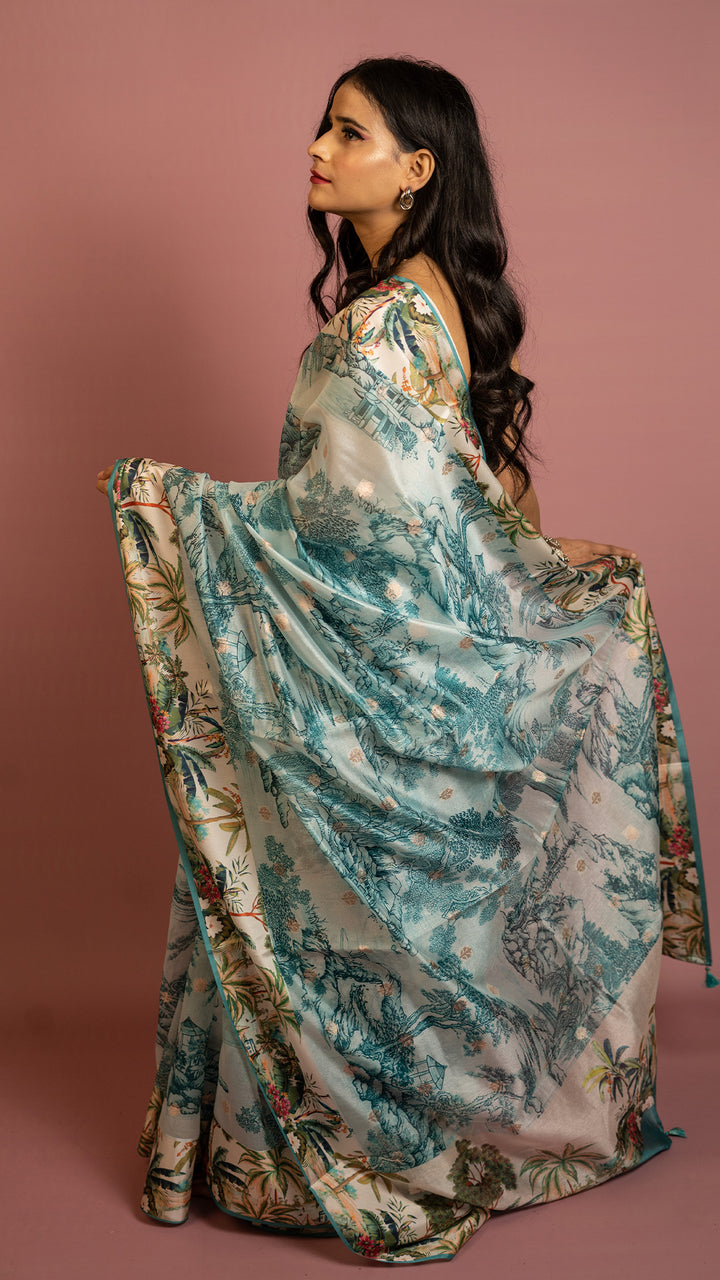 Aqua blue scenic printed designer saree with artistic landscape pattern and elegant drape
