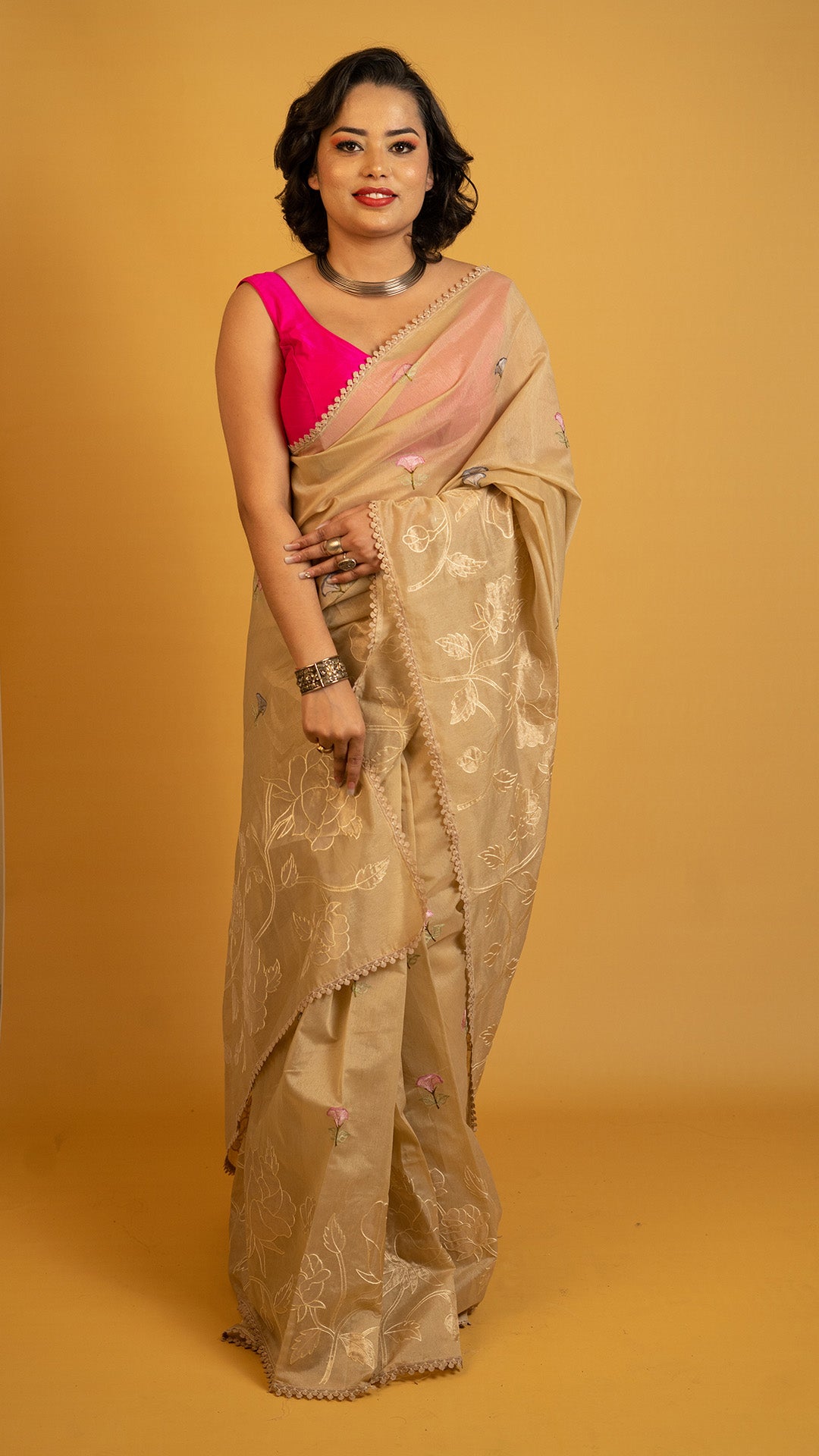 Beige organza saree with floral embroidery and elegant designer border