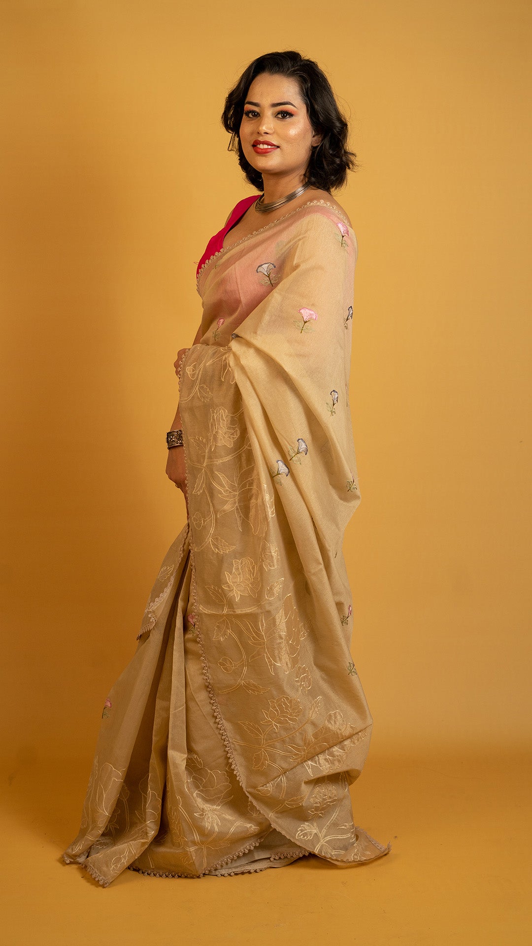 Beige organza saree with floral embroidery and elegant designer border