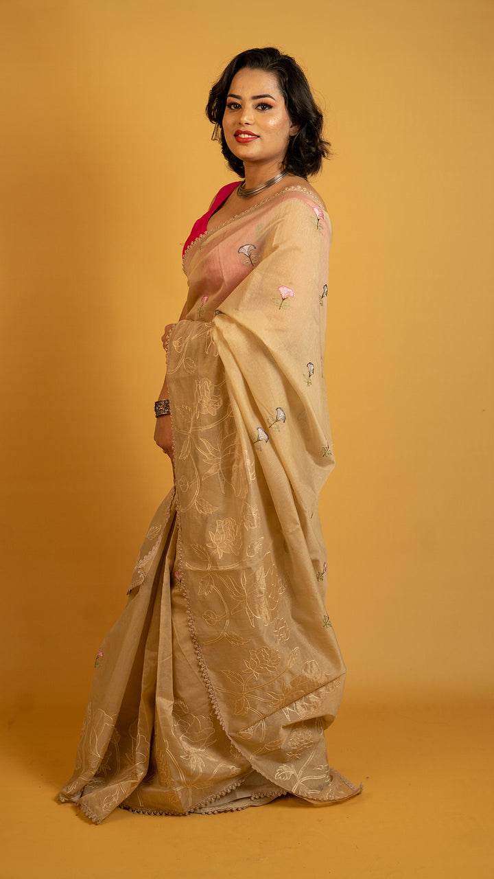 Beige organza saree with floral embroidery and elegant designer border
