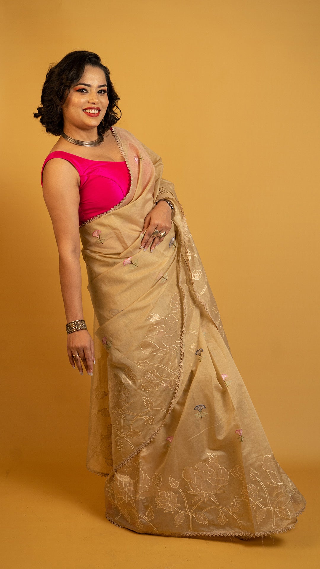 Beige organza saree with floral embroidery and elegant designer border