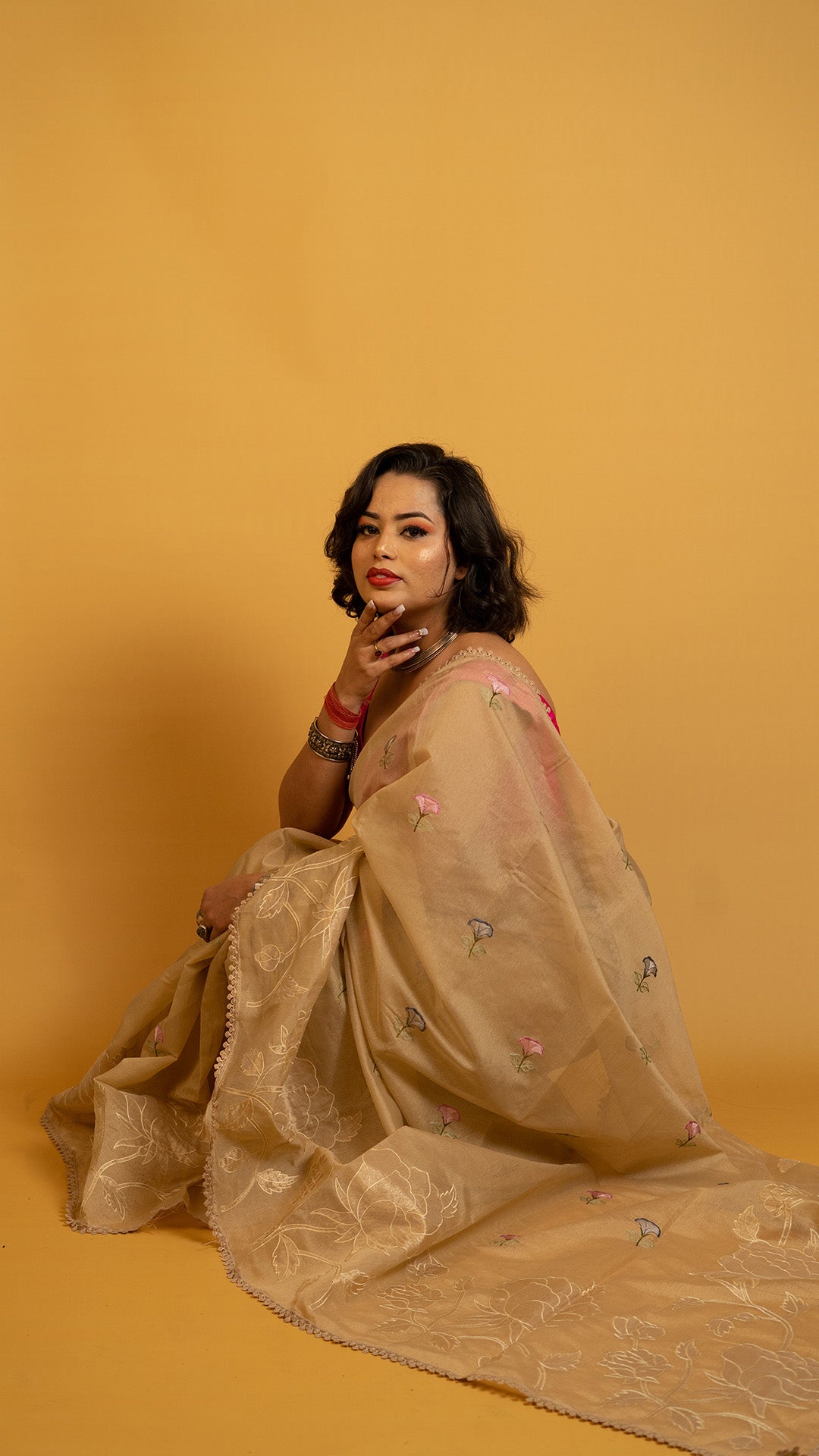 Beige organza saree with floral embroidery and elegant designer border