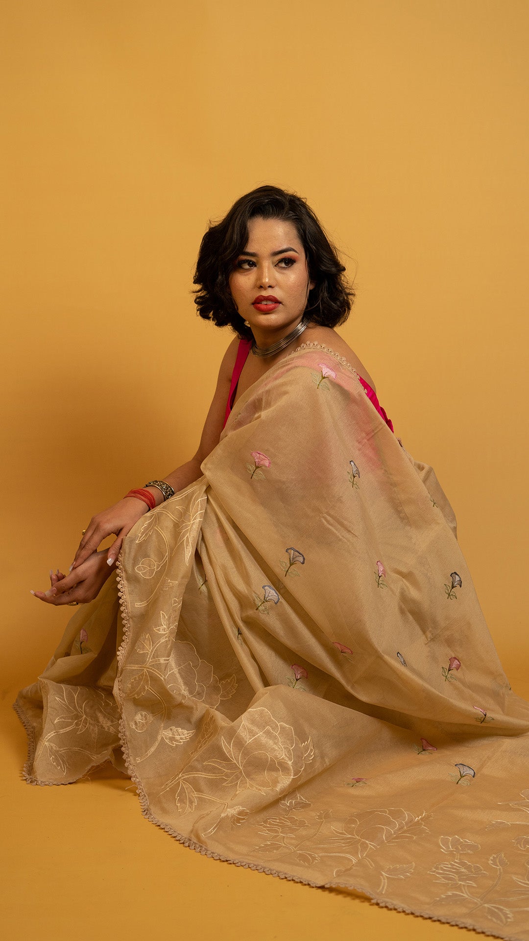 Beige organza saree with floral embroidery and elegant designer border