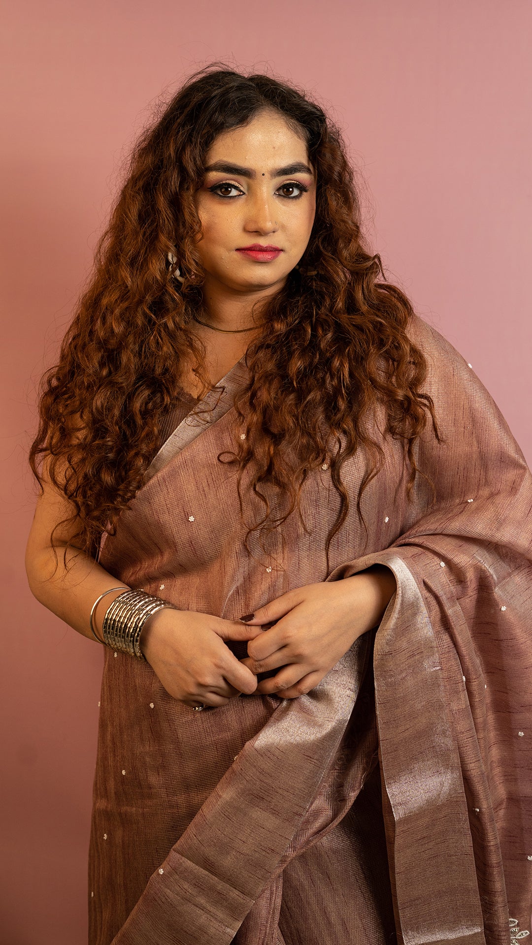 Brown lightweight saree with subtle embroidery and elegant traditional design