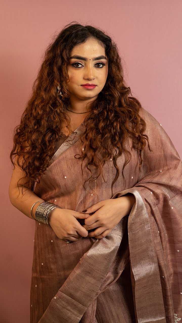Brown lightweight saree with subtle embroidery and elegant traditional design