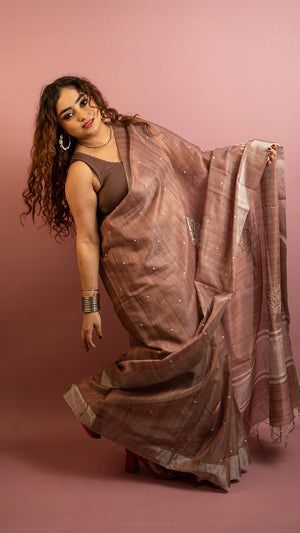 Brown lightweight saree with subtle embroidery and elegant traditional design