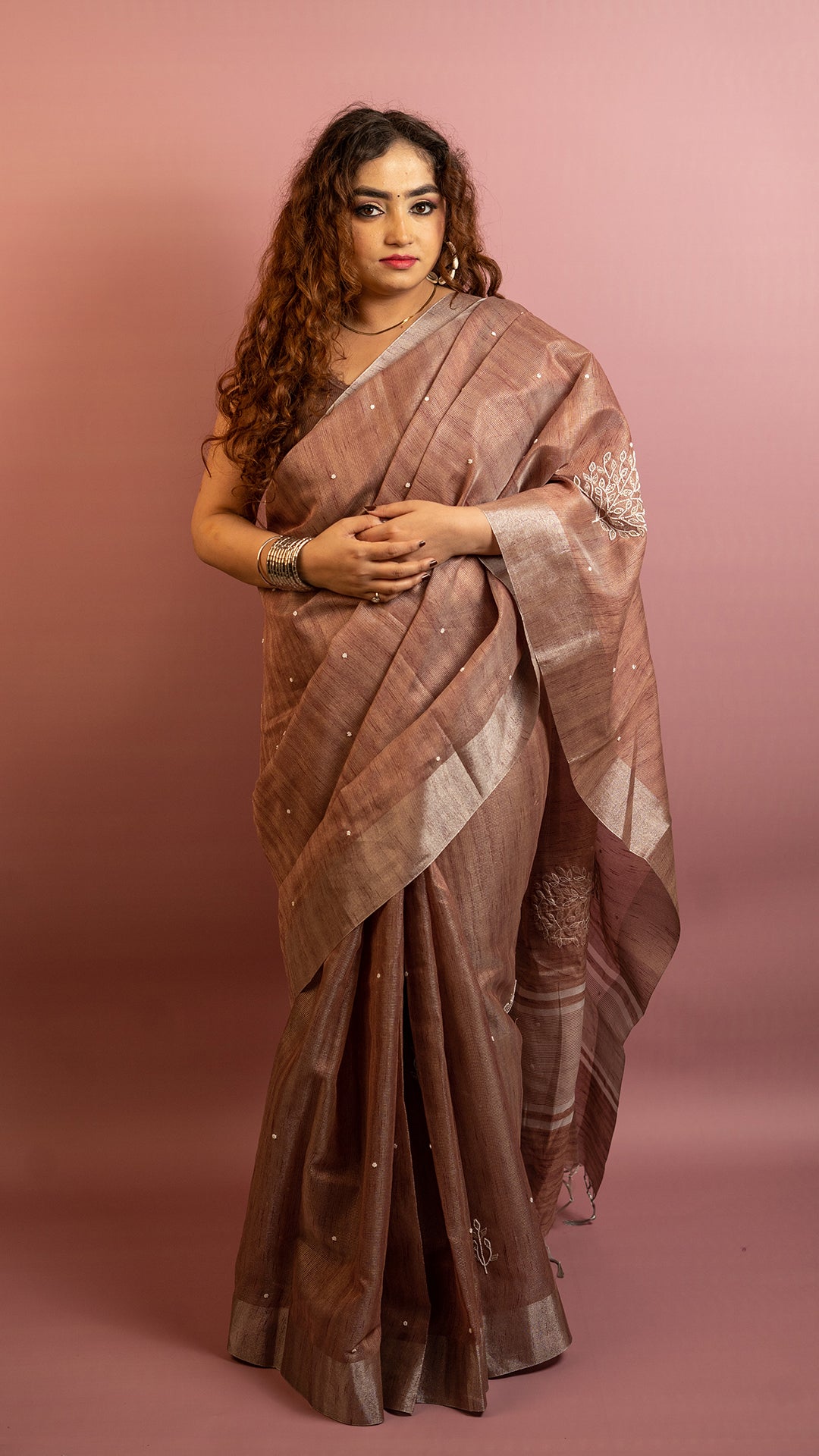 Brown lightweight saree with subtle embroidery and elegant traditional design