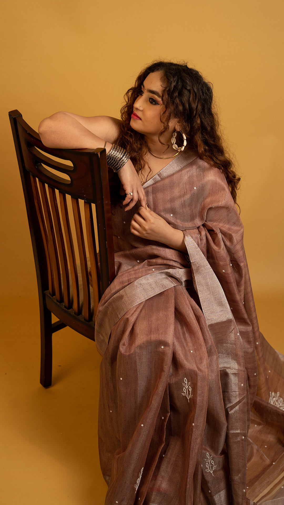 Brown lightweight saree with subtle embroidery and elegant traditional design