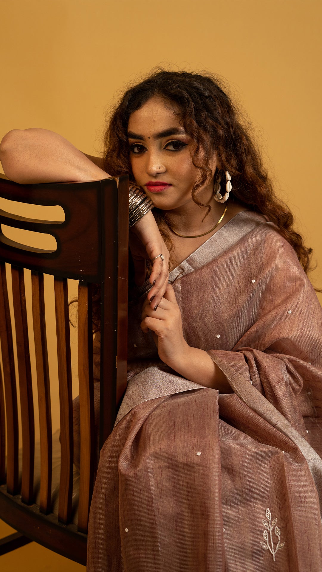 Brown lightweight saree with subtle embroidery and elegant traditional design