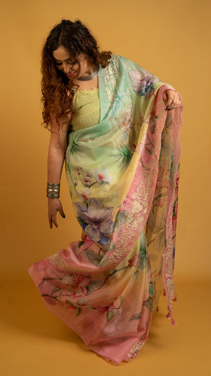 Pastel multicolor floral printed organza saree with lace border for festive and party wear
