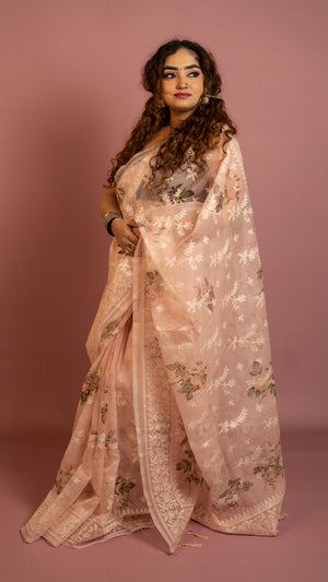 Peach floral embroidered organza saree with elegant border and lightweight sheer fabric
