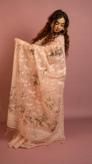 Peach floral embroidered organza saree with elegant border and lightweight sheer fabric