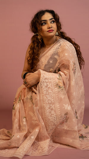 Peach floral embroidered organza saree with elegant border and lightweight sheer fabric