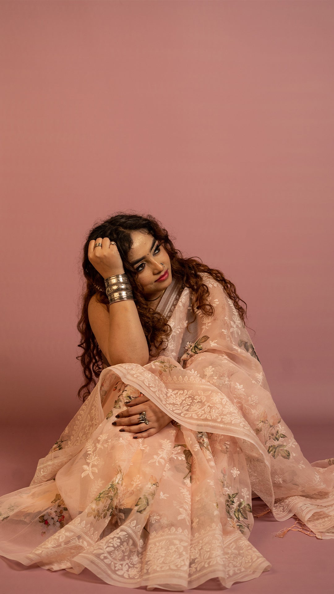 Peach floral embroidered organza saree with elegant border and lightweight sheer fabric