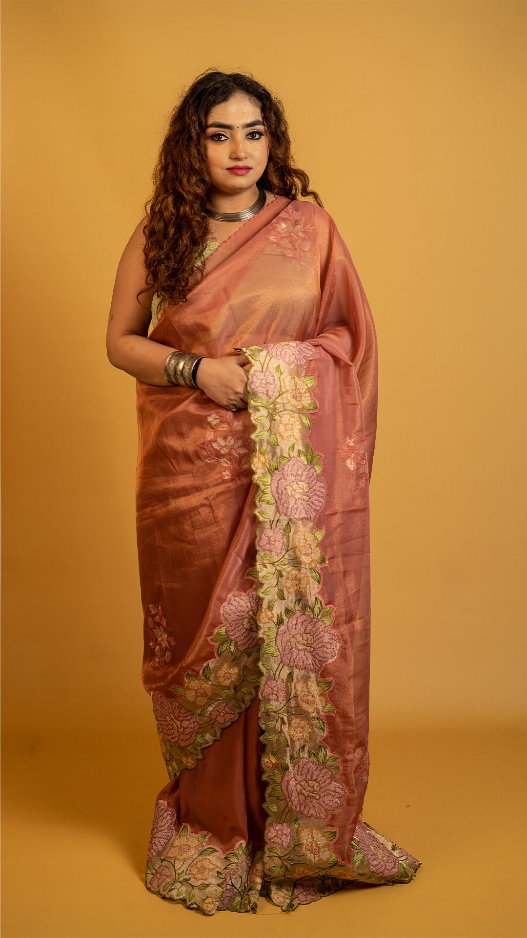Peach organza silk saree with heavy floral embroidered border and elegant design