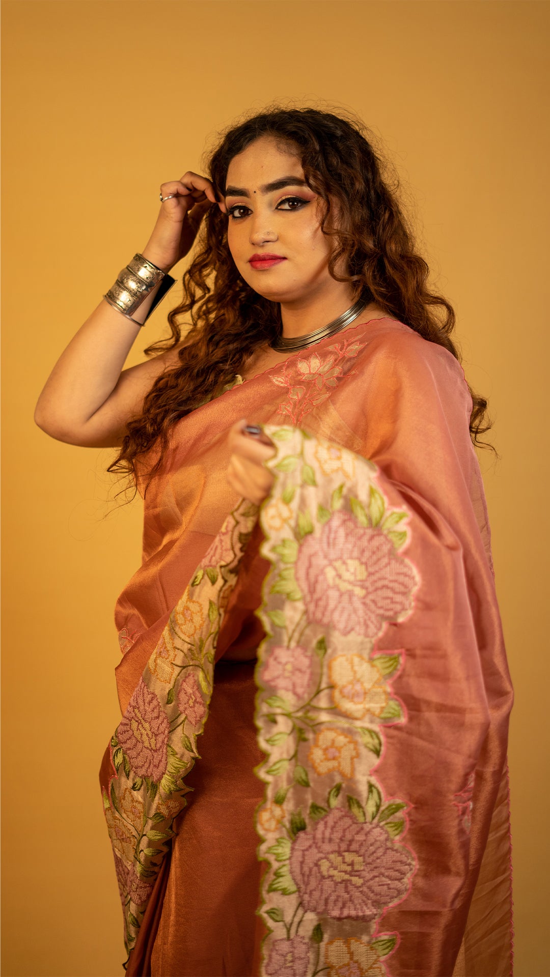 Peach organza silk saree with heavy floral embroidered border and elegant design