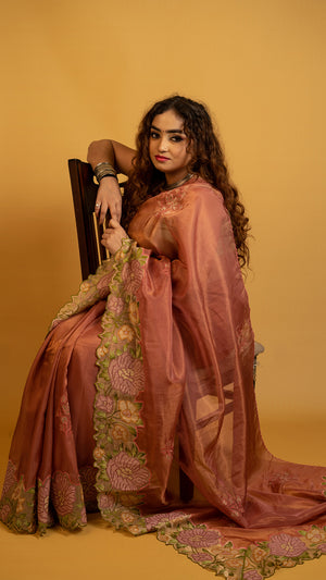 Peach organza silk saree with heavy floral embroidered border and elegant design
