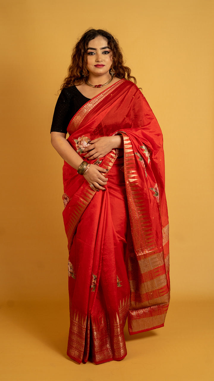 Red silk saree with zari border and floral motifs for wedding and festive wear