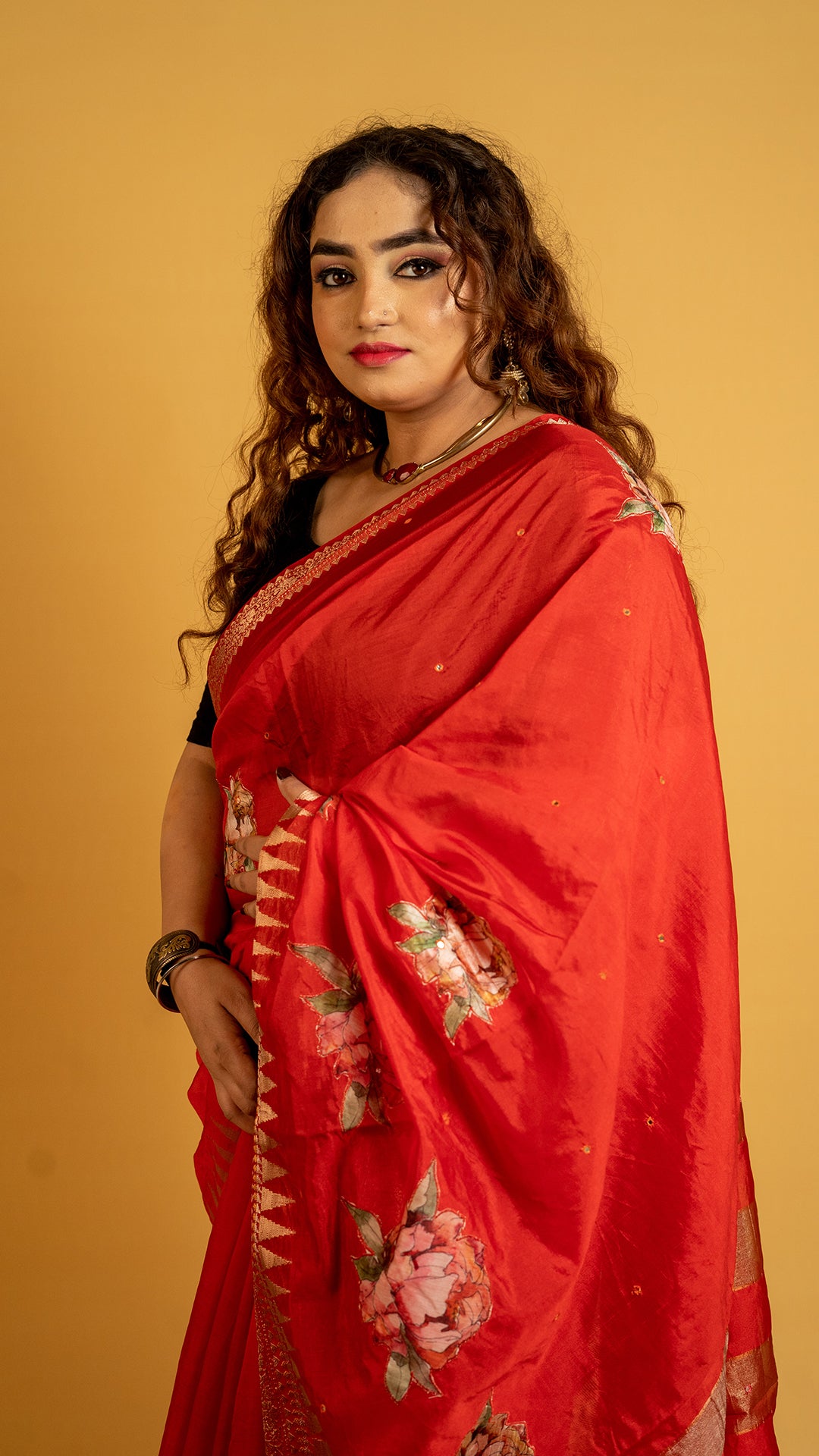Red silk saree with zari border and floral motifs for wedding and festive wear