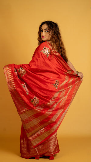 Red silk saree with zari border and floral motifs for wedding and festive wear