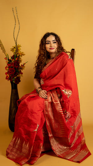 Red silk saree with zari border and floral motifs for wedding and festive wear