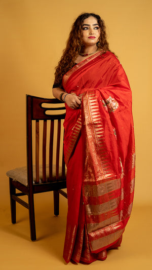 Red silk saree with zari border and floral motifs for wedding and festive wear