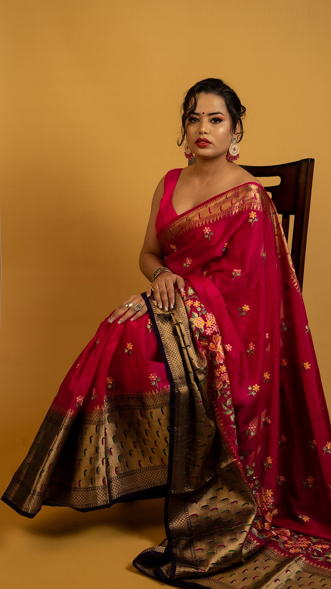 Royal red embroidered saree with antique gold zari border and floral design, perfect for wedding and festive wear