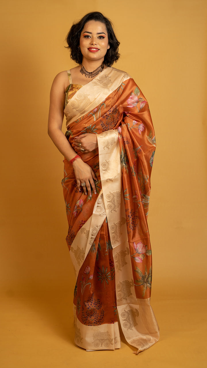 Rust orange silk saree with floral print and cream zari border