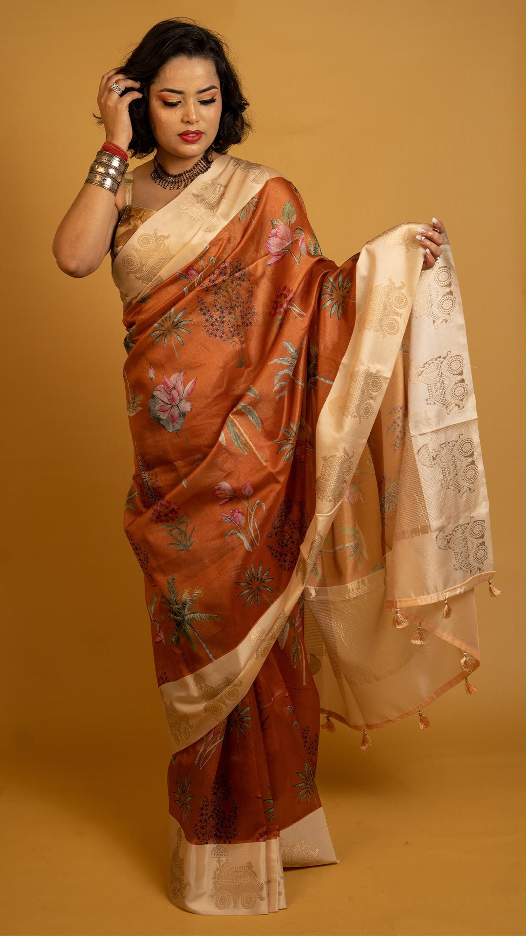 Rust orange silk saree with floral print and cream zari border