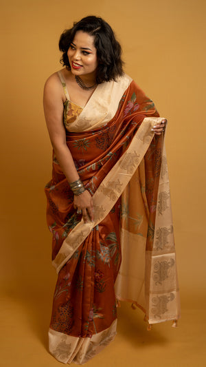 Rust orange silk saree with floral print and cream zari border