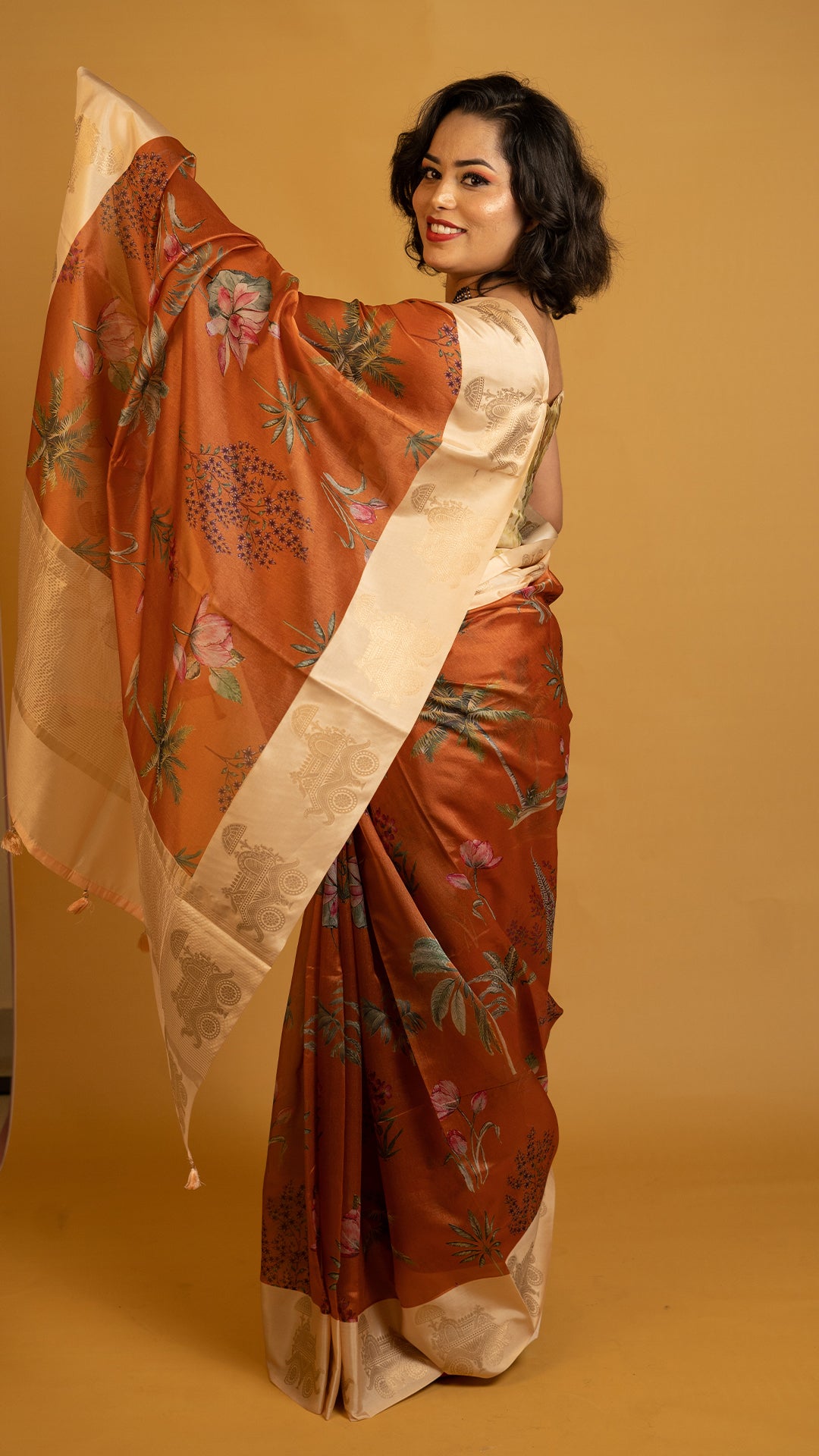 Rust orange silk saree with floral print and cream zari border