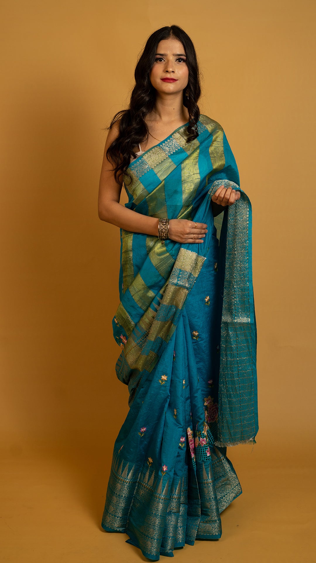 Teal blue silk saree with gold zari border and traditional woven design