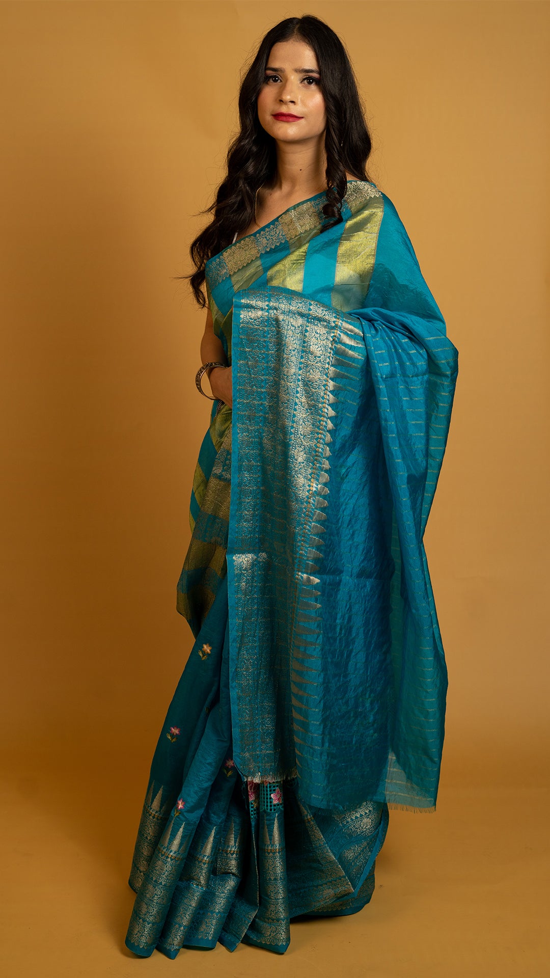 Teal blue silk saree with gold zari border and traditional woven design