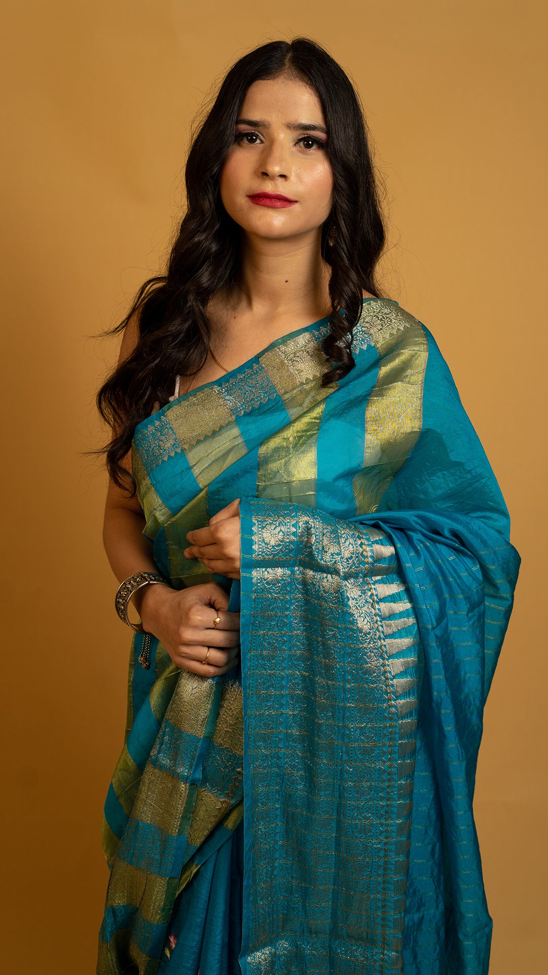 Teal blue silk saree with gold zari border and traditional woven design