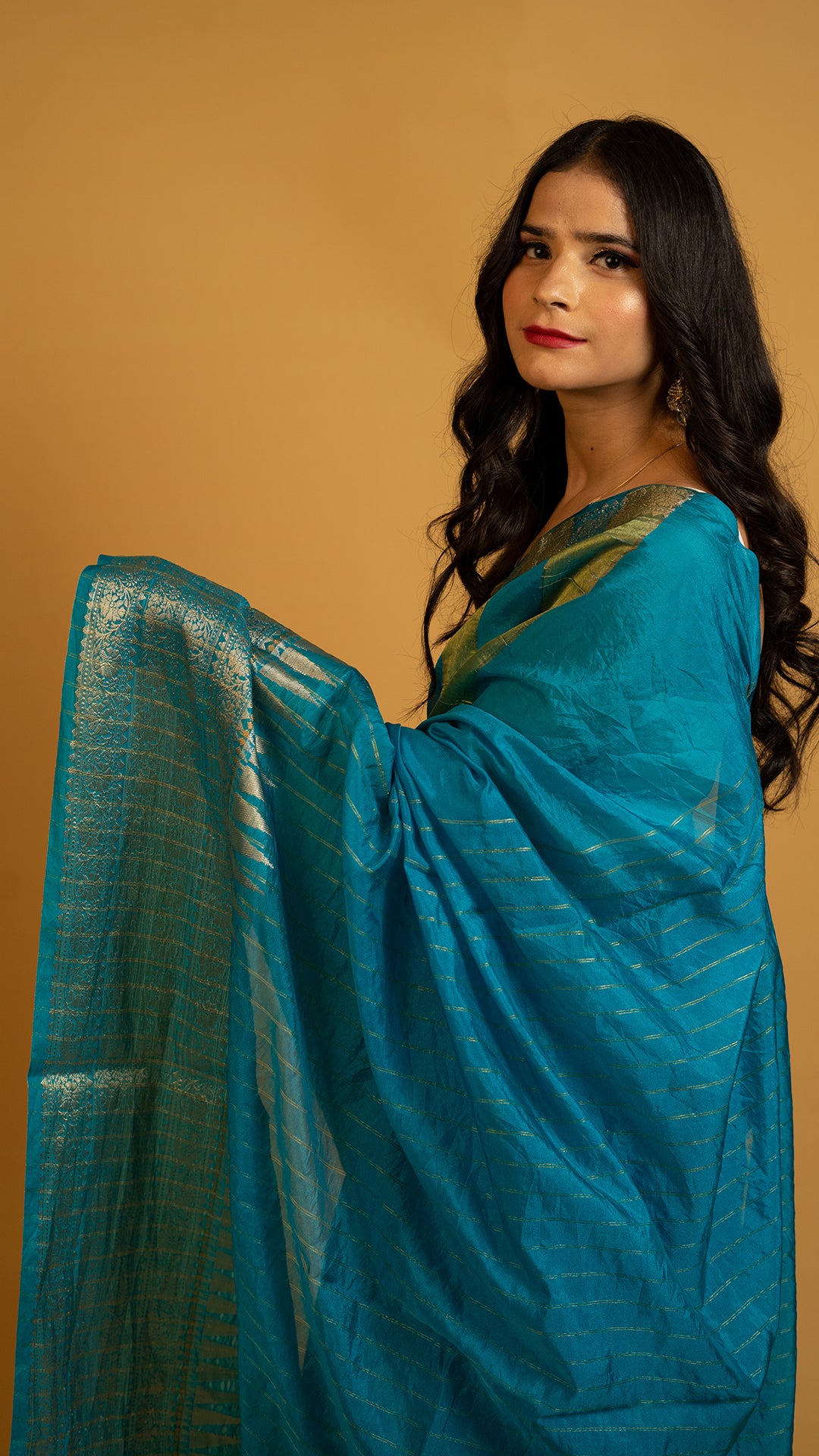 Teal blue silk saree with gold zari border and traditional woven design