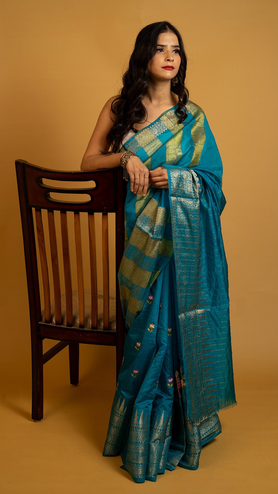 Teal blue silk saree with gold zari border and traditional woven design