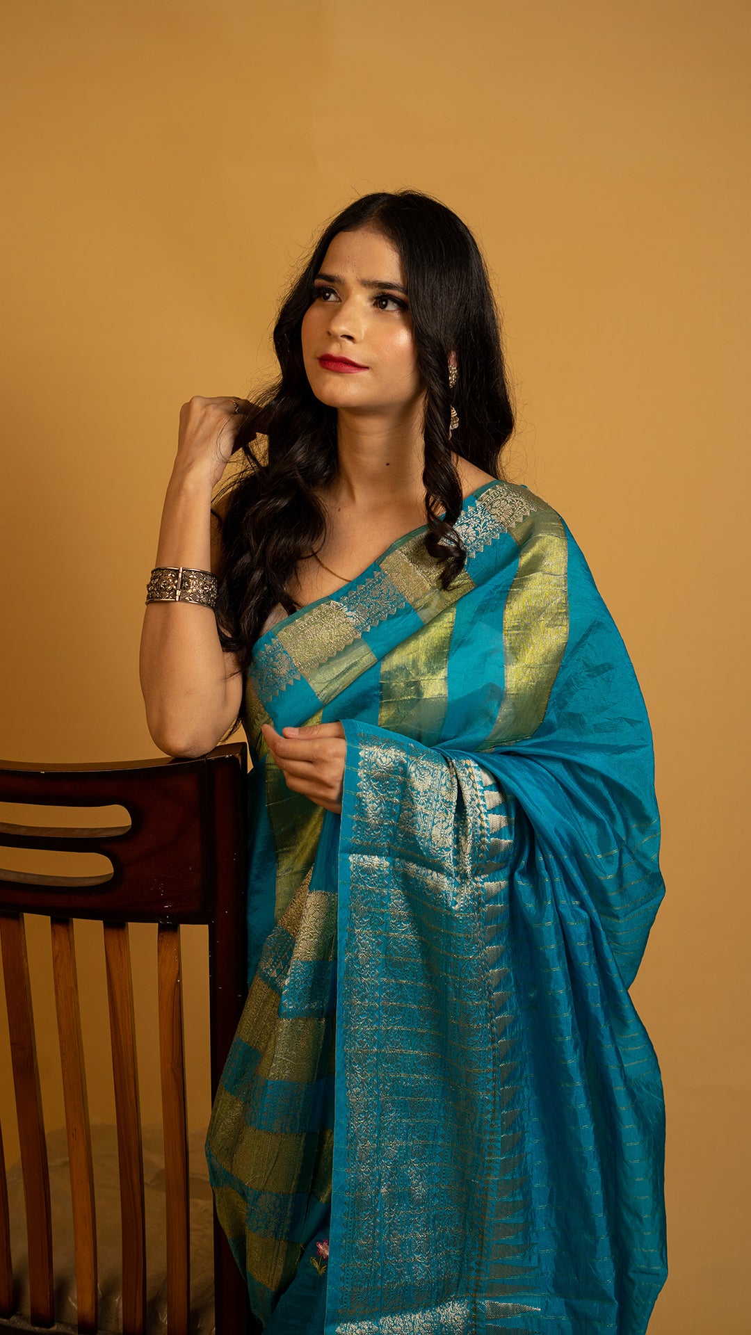 Teal blue silk saree with gold zari border and traditional woven design